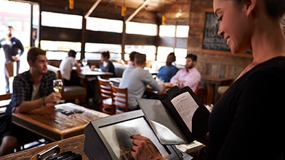 Smiling cashier at electronic till