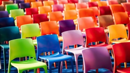 Rows with many colorful, plastic chairs and armchairs.