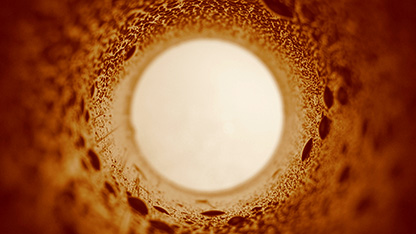 View from within large, textured, industrial pipe