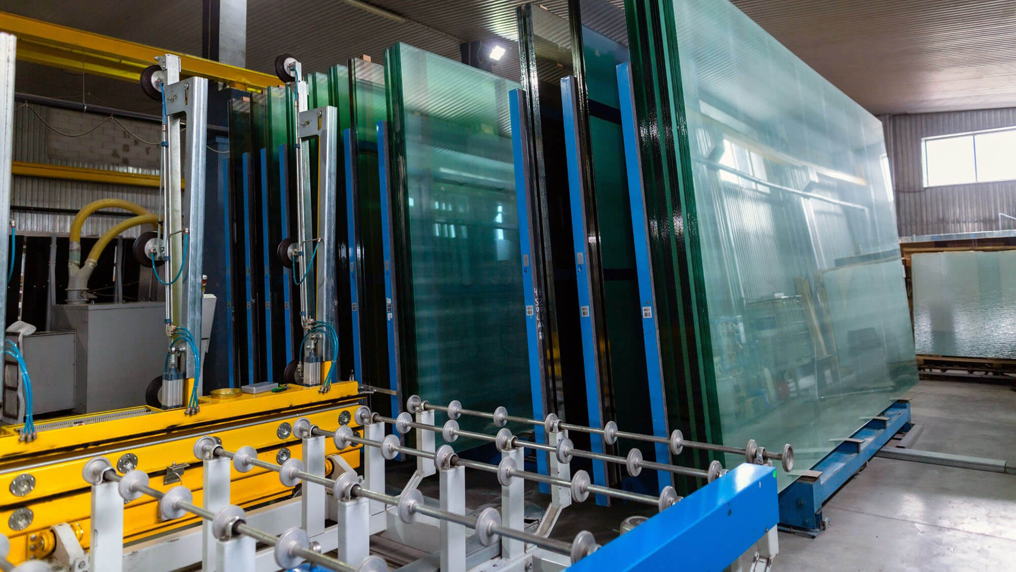 Factory for the production of double-glazed windows made of sheet glass. Sheet glass in pallets near the sheet glass cutting line. 