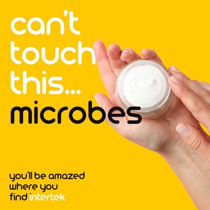 A hand about to dip into a jar of skincare product