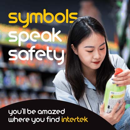 A woman in a grocery store reading the label on a bottle