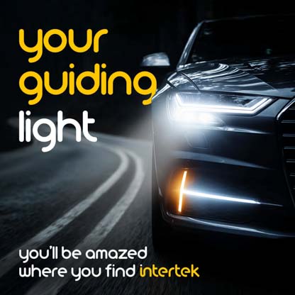 A view of the front of a car with its headlights illuminating the road