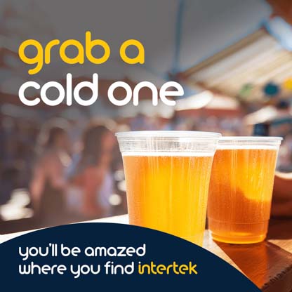 Two plastic cups of beer sitting on a restaurant counter