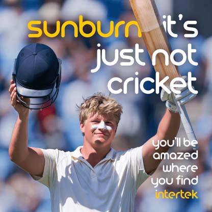 A cricket player holding up his equipment while wearing sunscreen